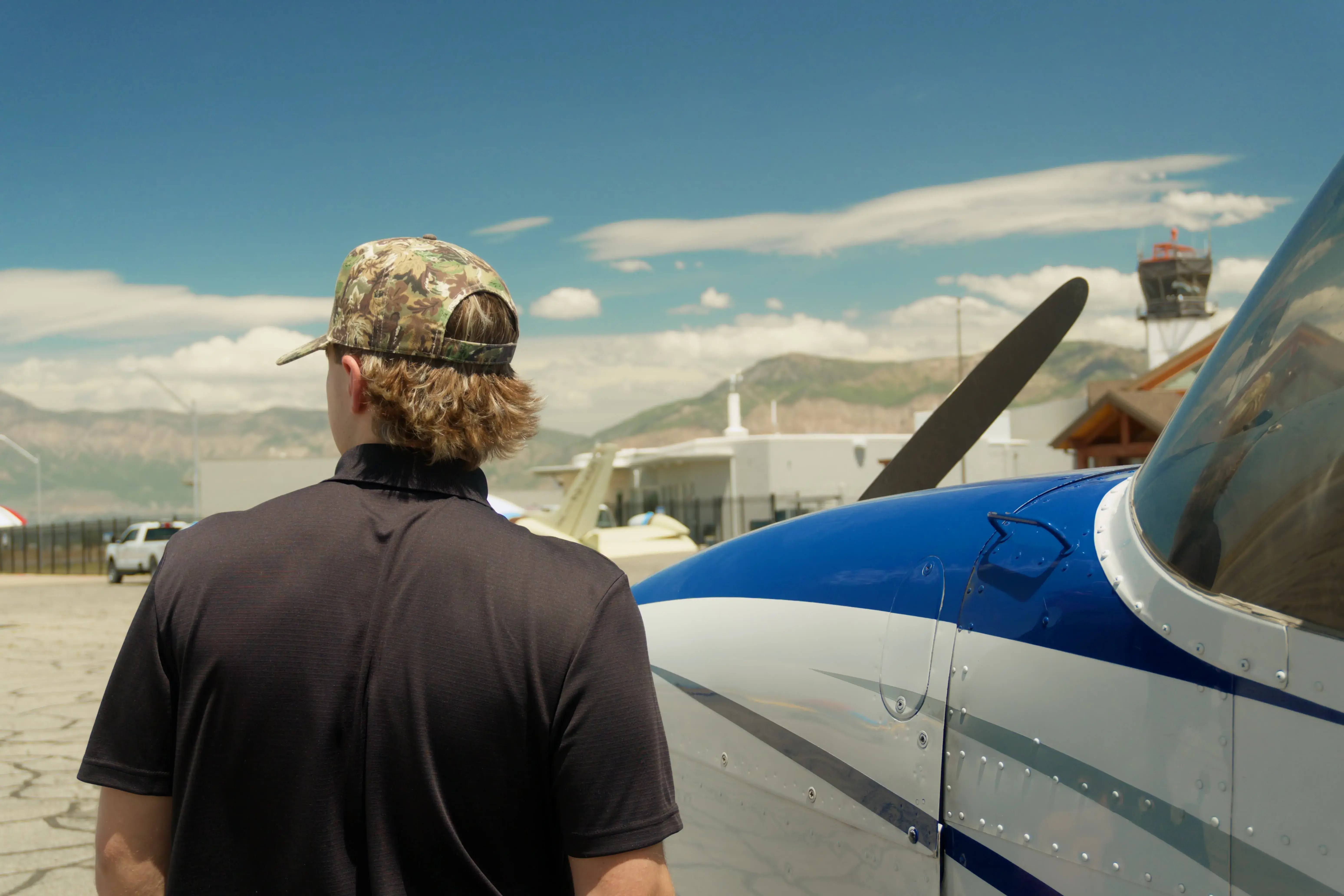 Two Blitz Aviation flight instructors on the wings of a training aircraft, symbolizing the journey to becoming a pilot.
