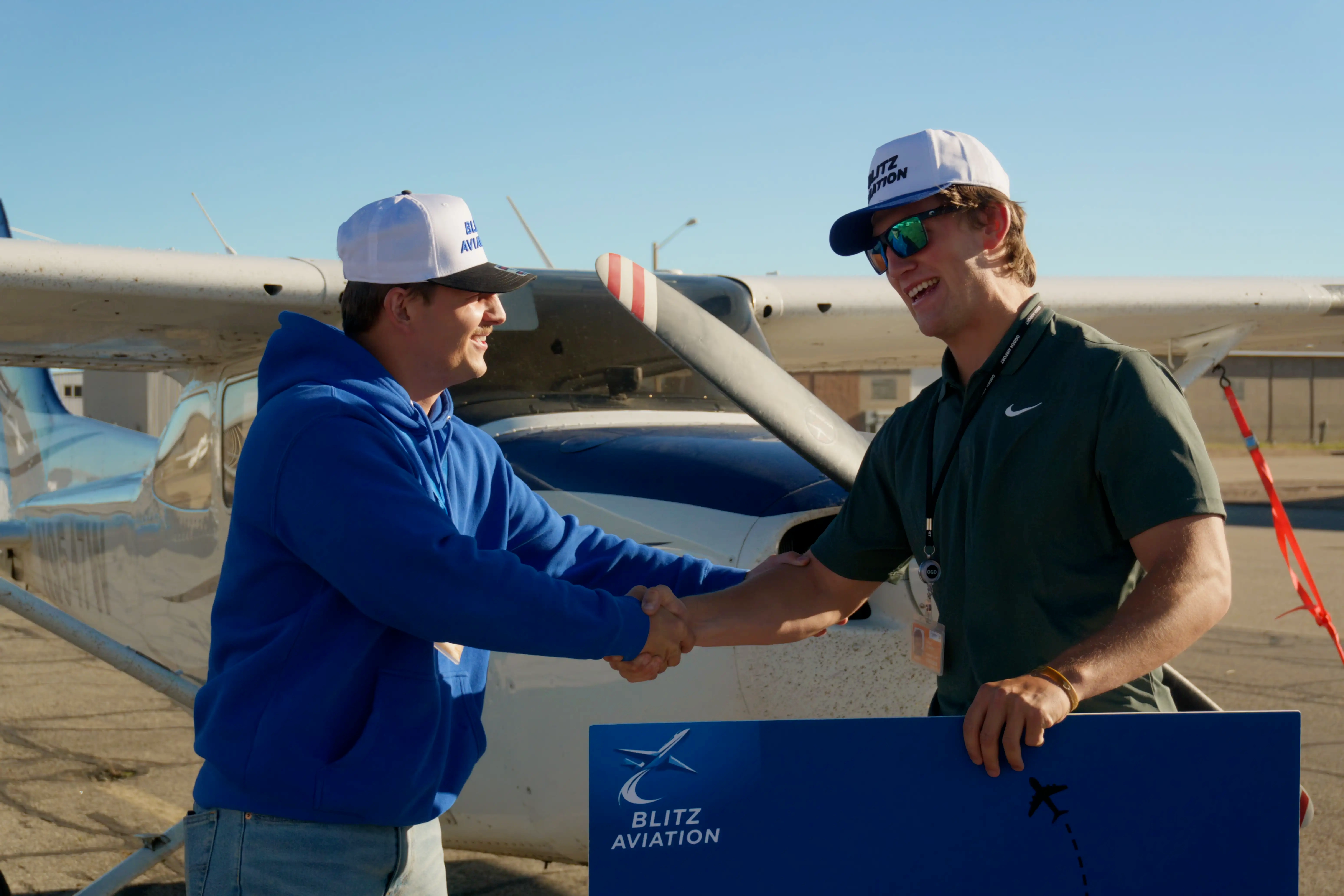 Student hording hands with CFI after passing check-ride for Certified Flight Instructor Instrument (CFII) at Blitz Aviation Salt City Lake Flight School