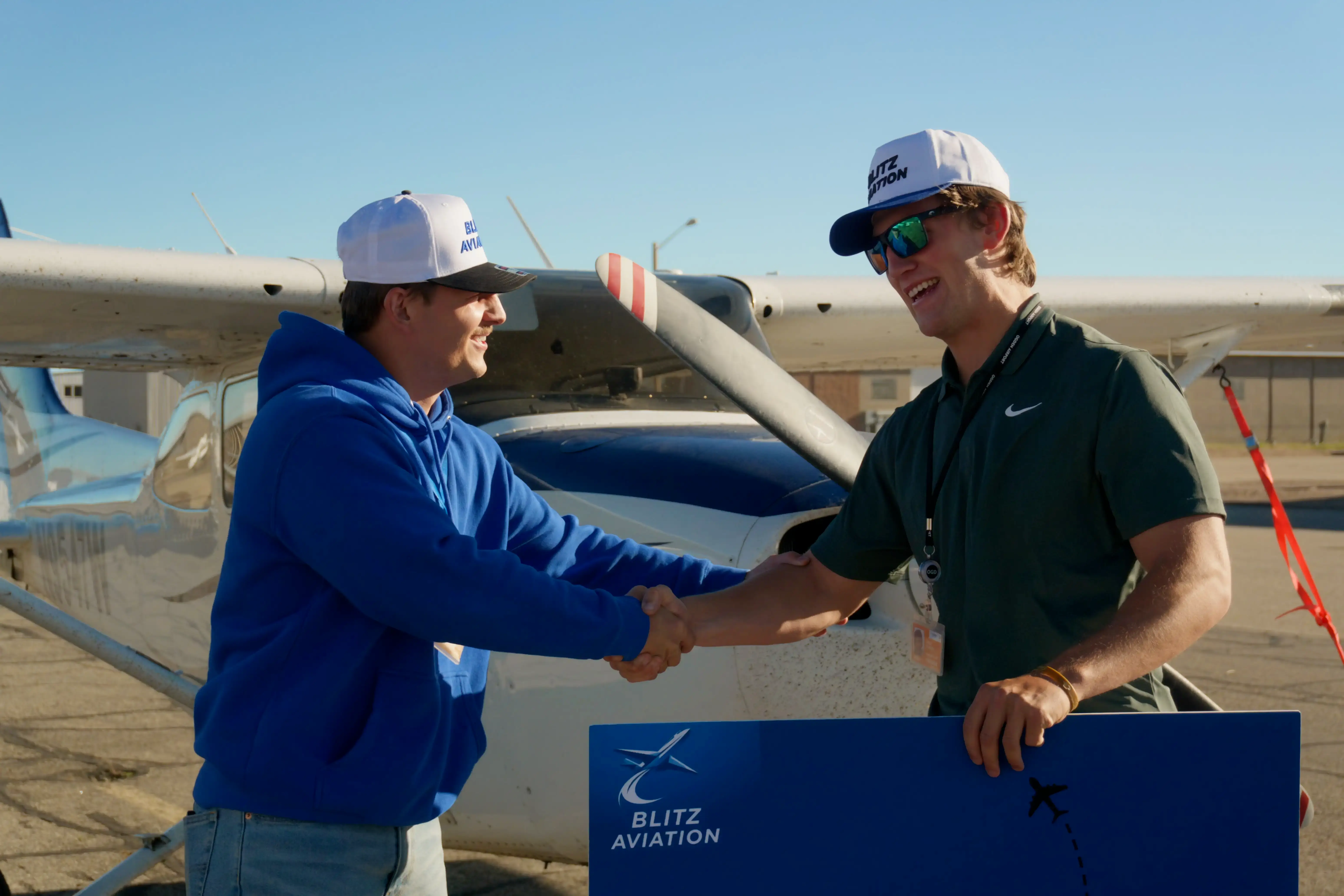 Student hording hands with CFI after passing check-ride for Certified Flight Instructor Instrument (CFII) at Blitz Aviation Salt City Lake Flight School