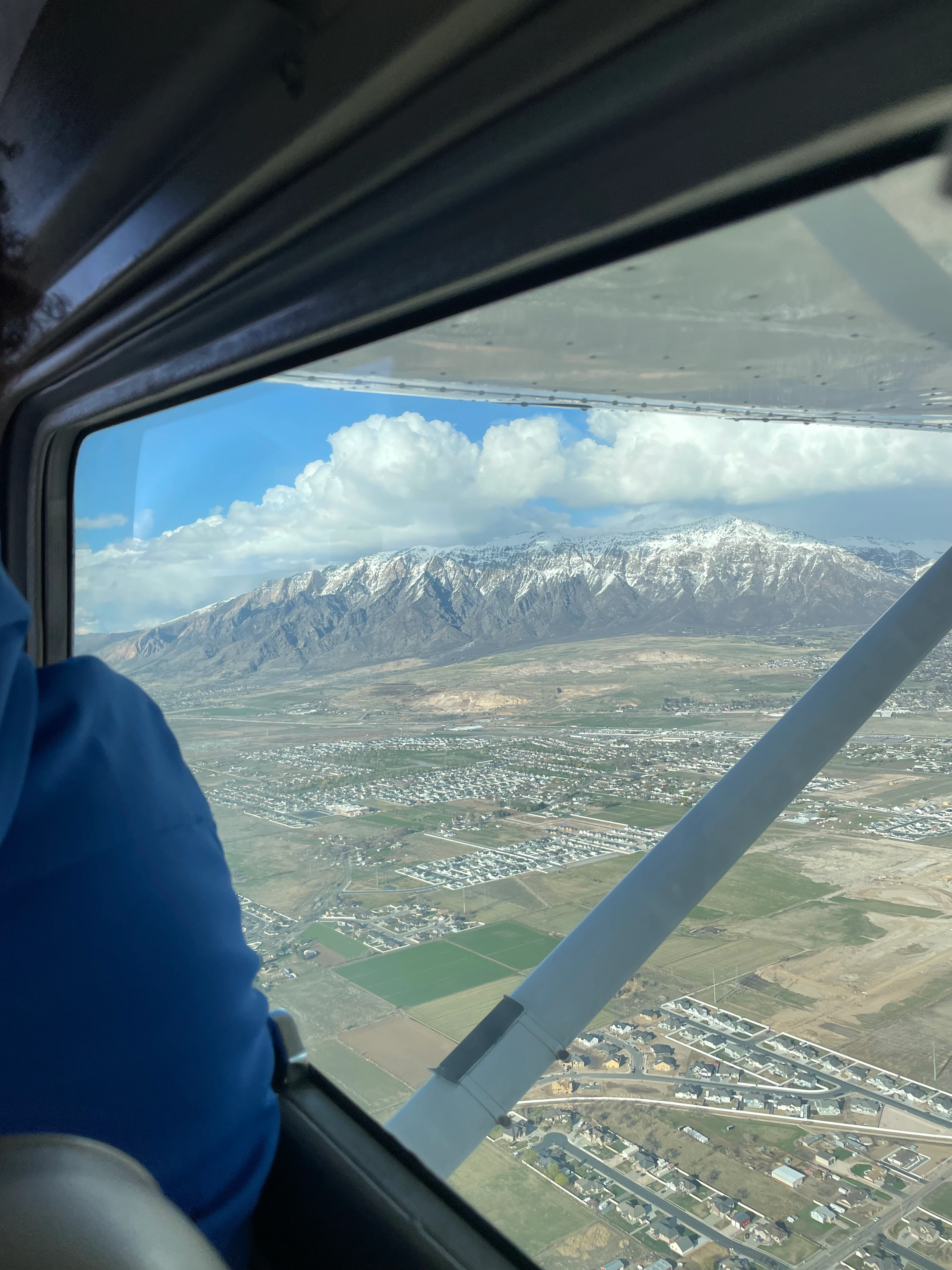 Blitz Aviation training aircraft flying along the Wasatch Mountains near Ogden